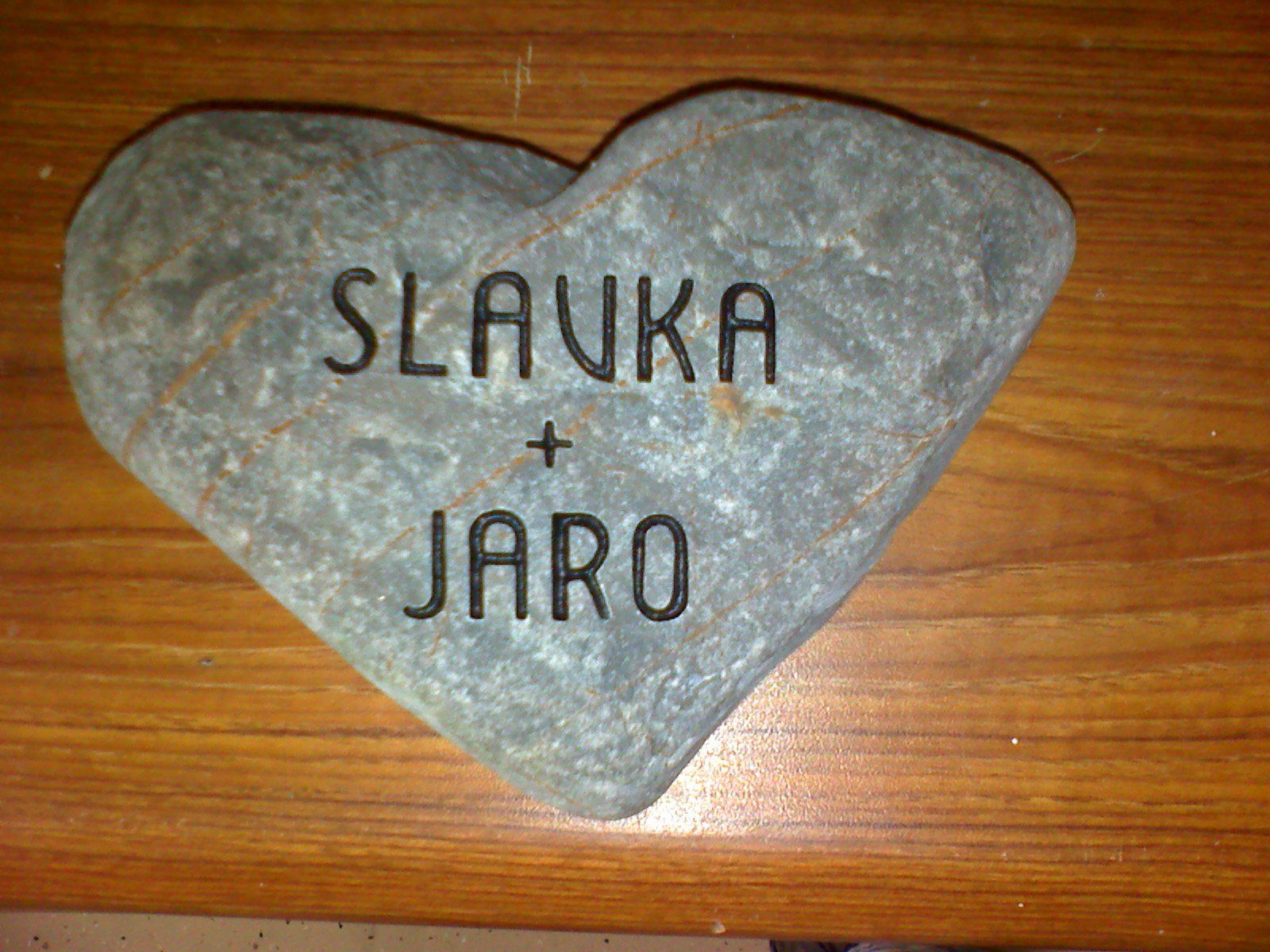 A naturally heart shaped beach stone lettered Slavka and Jaro
