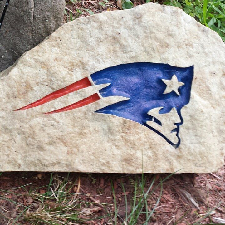 A fieldstone cut with a New England Patriots logo and colour filled in red, blue and white