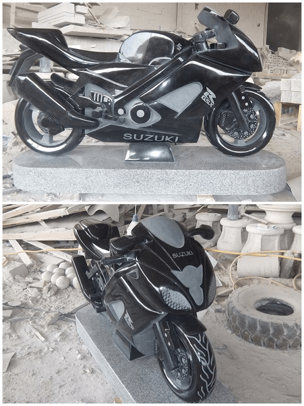 A full size sports motorcycle carved from black granite with polished and frosted surfaces, shown from two angles in a stoneworks yard